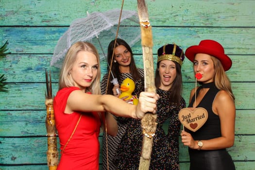 Just Married - 4 young ladies celebrate in front of a photo box