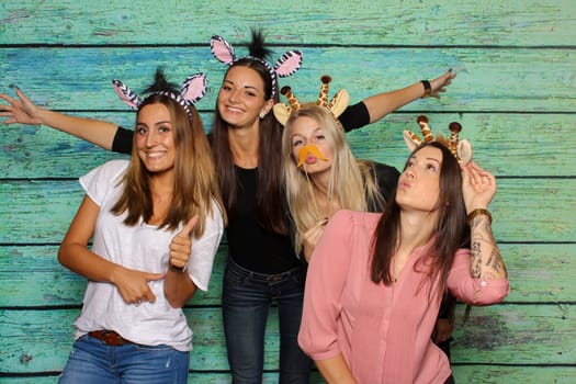 Young women silly in front of a photo box