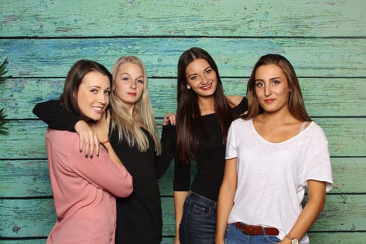4 girlfriends stand in front of a photo box
