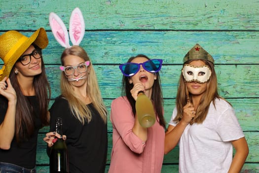 Group of girls with hats and bunny ears - party with photo booth