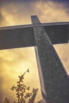 stone cross against dramatic cloudy sky,vintage effect