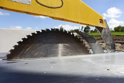 Circular table saw with saw blade at a construction site