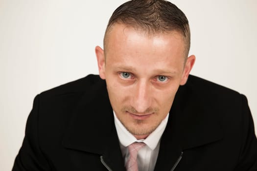 Head-and-shoulder portrait of a middle-aged man against a bright studio background.