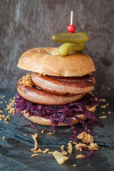 Grilled bratwurst in a broetchen with red cabbage and roestz onions