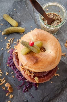 Grilled bratwurst in a broetchen with red cabbage and roestz onions