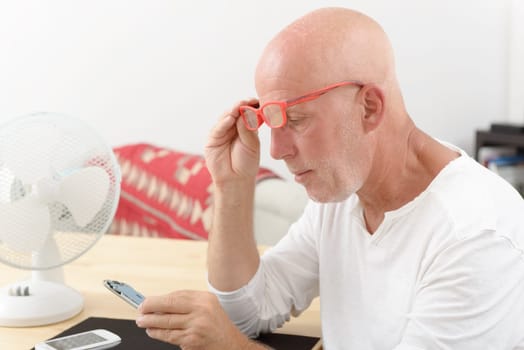 a mature man repaired a smartphone