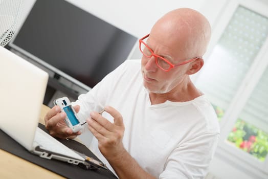 a mature man repaired a smartphone