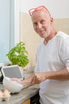 a mature man in the kitchen