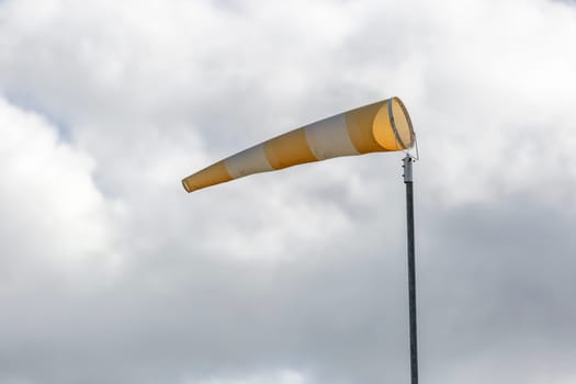 Wind Direction Indicator with a cloudy sky.