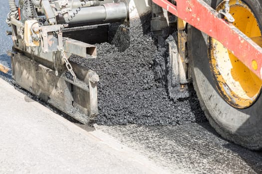Asphalt Paver Laying Down Asphalt close up.