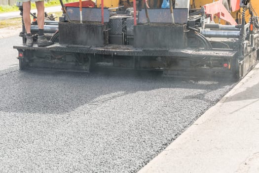 Asphalt Paver Laying Down Asphalt close up.