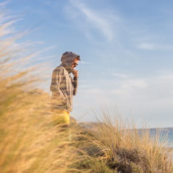 Sporty active man looking at distance, enjoying beautiful nature, freedom and life at serene landscape at Balos beach. Active lifestyle outdoors.