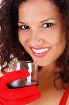 A beautiful young woman holding a win glass with red cloves, smiling,.closeup isolated for white background..