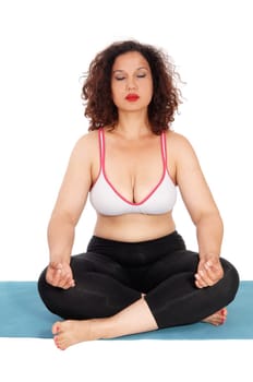 A lovely young woman in exercise outfit sitting on a matt with eye's.closed doing yoga, isolated for white background..