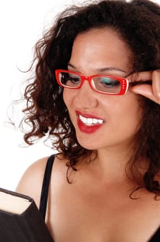A closeup image of a beautiful young woman wearing red glasses and.holding a book in her hands, isolated for white background..