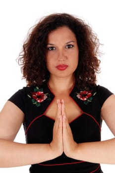 A gorgeous woman with curly brunette hair folding her hands and.praying, isolated for white background..