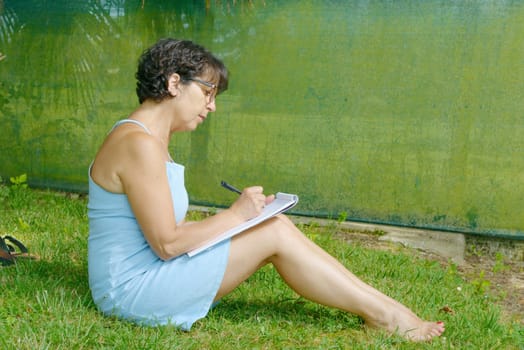 a mature woman with glasses in the garden