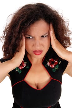 A closeup image of a pretty woman in a black dress holding booths hands.on her head for migraine pain, isolated for white background..
