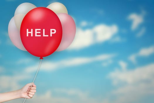 Hand Holding help Balloon with sky blurred background