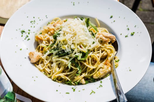 Spaghetti Bolognese. Plates of Italian spaghetti,spinach,chicken and Parmesan cheese..