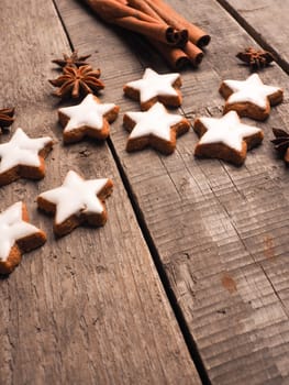 Christmas bakery with cinnamon stars on an old wooden table with cinnamon sticks and star anise