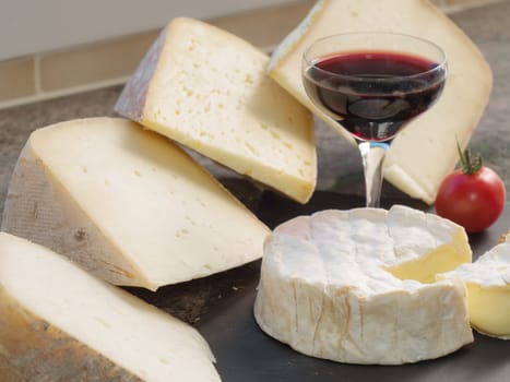 the different french cheeses with a glass of red wine