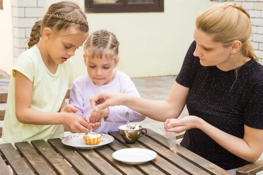 Mother and two daughters sprinkled cupcakes Easter candy sprinkles