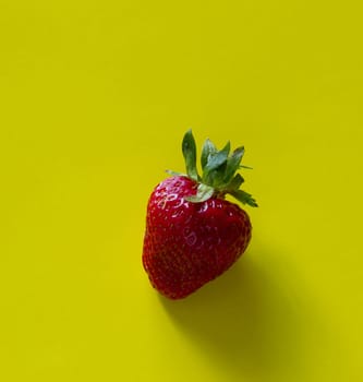 The fresh sweet strawberry on yellow background