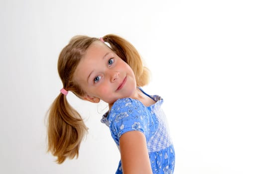 portrait of a little smiling girl with pigtails
