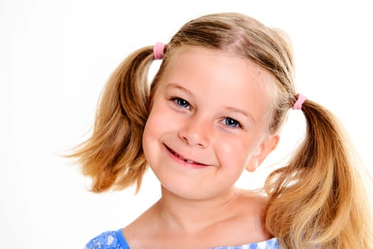 portrait of a little smiling girl with pigtails