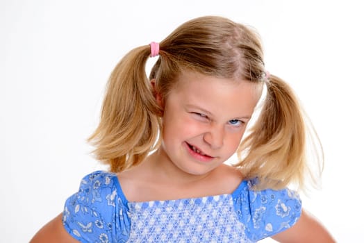 portrait of a little bold girl with pigtails