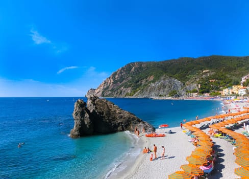 Monterosso, Italy - September 09, 2015: People on the coastline of Monterosso in Italy. Monterosso is one of five famous coastline villages in the Cinque Terre National Park.