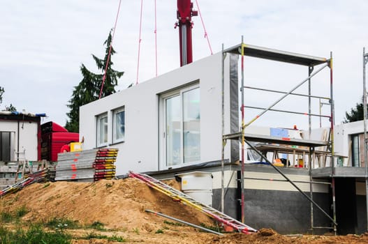 Installation of a house wall on a prefabricated house.