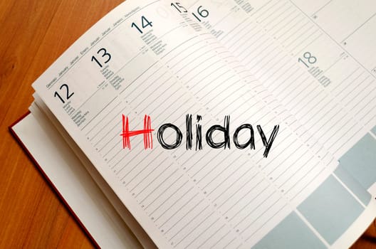 Holiday text concept write on notebook