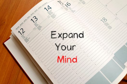 Expand your mind text concept write on notebook