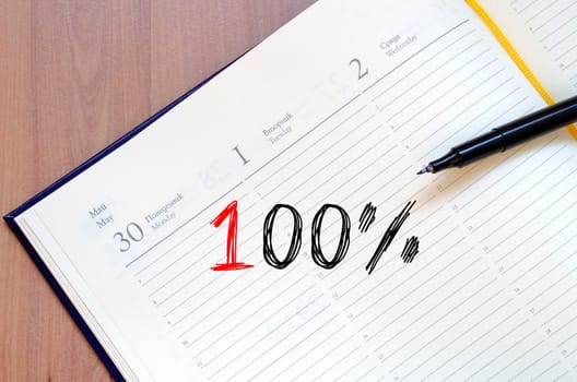 One hundred percent symbol text concept write on notebook
