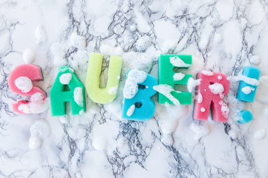 Plaster sponge as lettering Clean on background made of marble
