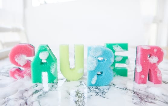 Plaster sponge as lettering Clean on background made of marble