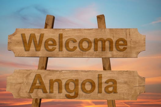 welcome to angola sing on wood background