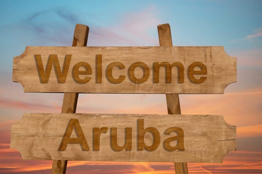 welcome to aruba sing on wood background