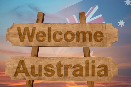 welcome to australia sing on wood background with blending national flag