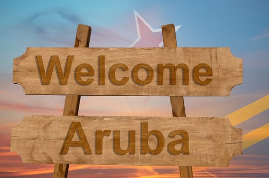 welcome to aruba sing on wood background with blending national flag