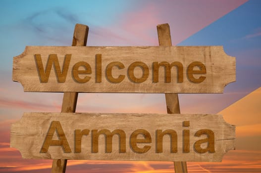welcome to armenia sing on wood background with blending national flag