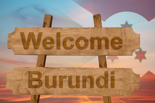 welcome to burundi sing on wood background with blending national flag