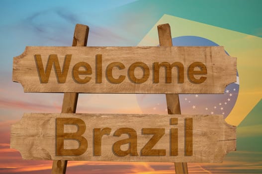 welcome to brazil sing on wood background with blending national flag