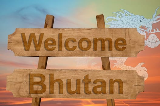 welcome to bhutan sing on wood background with blending national flag