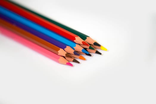 colorful pencils isolated on a white paper background