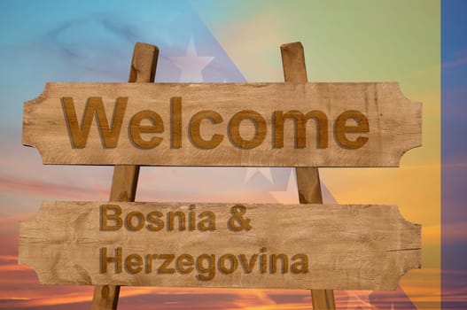 welcome to bosnia & herzegovina sing on wood background with blending national flag