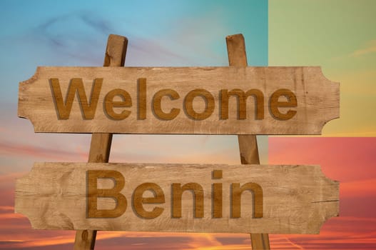 welcome to benin sing on wood background with blending national flag