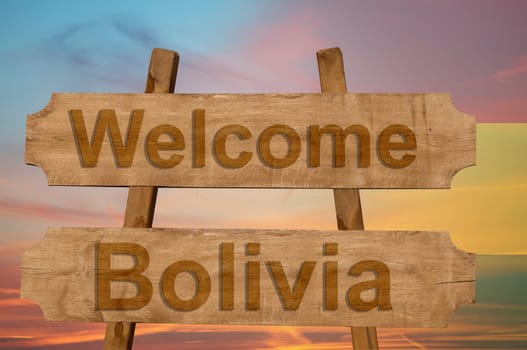 welcome to bolivia sing on wood background with blending national flag